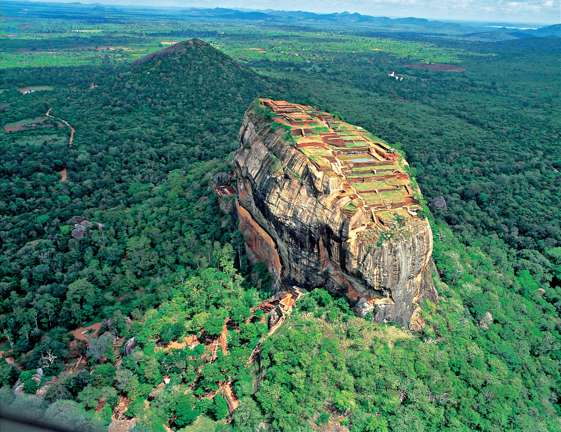 Aerial view of Sigiriya rock fortress surrounded by green forest