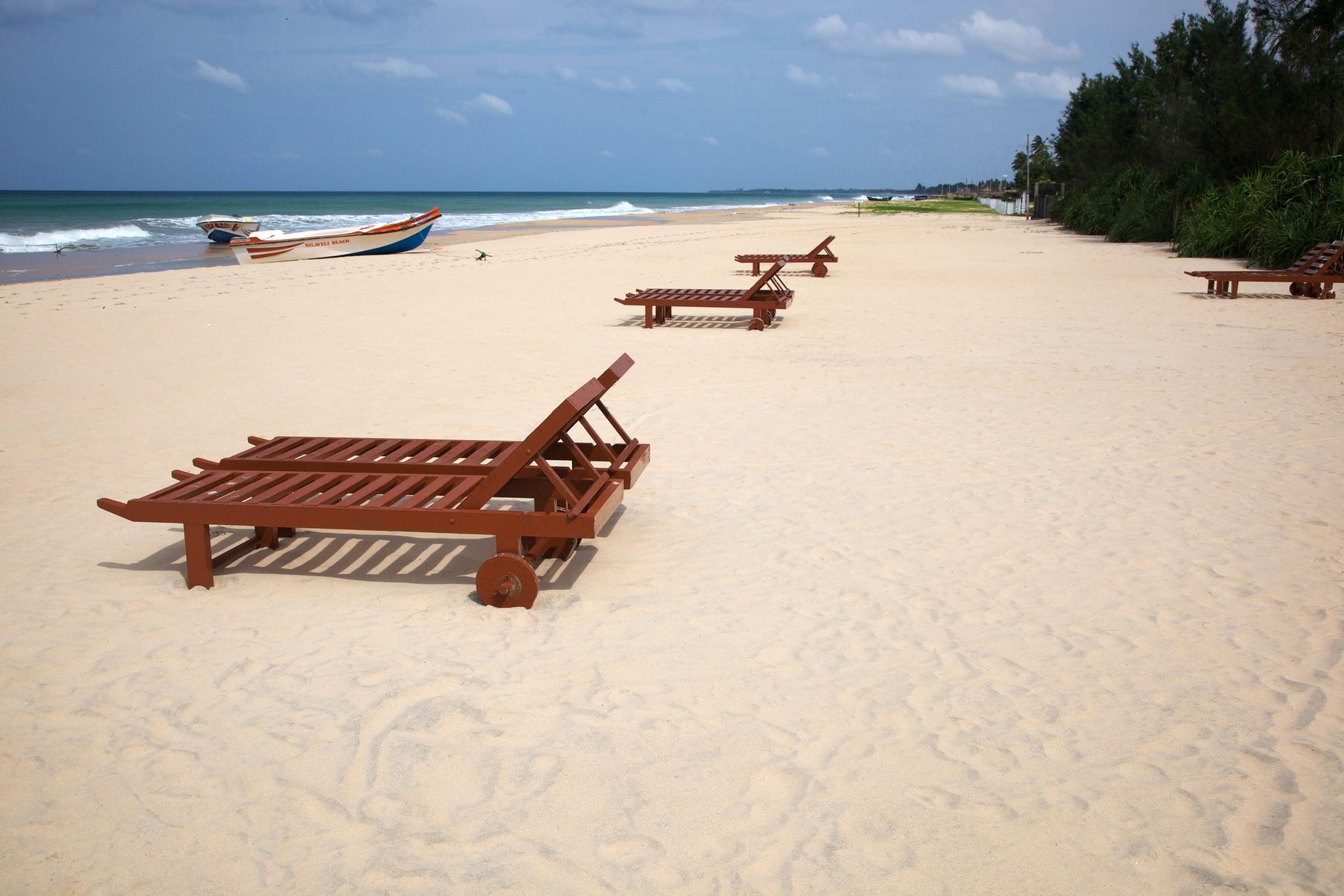 Quiet pale sand and blue water at Nilaveli Beach, Sri Lanka